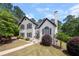 Charming two-story home with landscaped front yard, walkway, and lush trees at 9206 Denmeade Trce, Douglasville, GA 30135