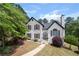 Charming two-story home with landscaped front yard, walkway, and lush trees at 9206 Denmeade Trce, Douglasville, GA 30135