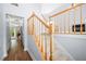 Open foyer showcasing hardwood floors and staircase with wood railing at 9206 Denmeade Trce, Douglasville, GA 30135