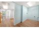 Hallway leading to multiple rooms with hardwood floors and neutral paint, creating a cohesive flow at 9206 Denmeade Trce, Douglasville, GA 30135