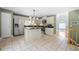 Kitchen featuring an island, stainless steel appliances, and easy access to the dining area at 9206 Denmeade Trce, Douglasville, GA 30135