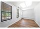 Well-lit living room featuring hardwood floors, windows with blinds, and a cozy atmosphere at 9206 Denmeade Trce, Douglasville, GA 30135