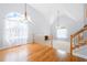 Bright living room features hardwood floors, vaulted ceilings, and large windows at 9206 Denmeade Trce, Douglasville, GA 30135