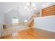 Open living area with a fireplace, wooden staircase, and view of the second floor at 9206 Denmeade Trce, Douglasville, GA 30135