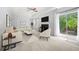 Stylishly furnished living room with a fireplace, comfortable seating, and view of the backyard at 9206 Denmeade Trce, Douglasville, GA 30135