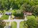 Overhead view showing a home surrounded by mature trees with long driveway at 35 Pawn Dr, Carrollton, GA 30116