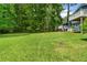 Expansive backyard with lush green grass and mature trees providing privacy at 35 Pawn Dr, Carrollton, GA 30116
