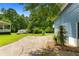 Expansive backyard with green lawn and parking pad that has a small storage shed behind it at 35 Pawn Dr, Carrollton, GA 30116