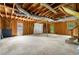 Unfinished basement featuring concrete flooring, exposed beams, and garage door at 35 Pawn Dr, Carrollton, GA 30116