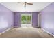 Bedroom with carpeting, ceiling fan, and sliding glass doors to balcony at 35 Pawn Dr, Carrollton, GA 30116