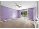 Bedroom with carpeting, ceiling fan, and sliding glass doors to balcony at 35 Pawn Dr, Carrollton, GA 30116