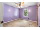 Bedroom featuring carpeting, ceiling fan, and window with natural light at 35 Pawn Dr, Carrollton, GA 30116