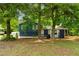 Charming single-story home with blue siding, nestled among mature trees and a well-maintained lawn at 35 Pawn Dr, Carrollton, GA 30116