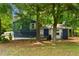 Charming blue house exterior with a well-maintained lawn and mature trees in a peaceful setting at 35 Pawn Dr, Carrollton, GA 30116