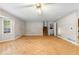 View of living room with parquet floors, fan, window, stairs and exterior door at 35 Pawn Dr, Carrollton, GA 30116