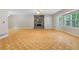 Spacious living room with parquet floors, stone fireplace, ceiling fan and natural light at 35 Pawn Dr, Carrollton, GA 30116
