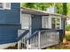 Close-up of the covered porch with blue railings and steps leading to the front door at 35 Pawn Dr, Carrollton, GA 30116