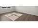 A simple bedroom featuring hardwood floors, white walls, and a large window with a scenic view at 48 Lakeview Pt, Dallas, GA 30157