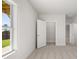 New construction bedroom with carpet, walk-in closet, and view of lawn at 48 Lakeview Pt, Dallas, GA 30157