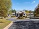 Circular driveway entrance to a luxury clubhouse with manicured flower beds at 48 Lakeview Pt, Dallas, GA 30157