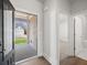 View from entryway with hardwood floors, view of backyard and open door to room with carpet flooring at 48 Lakeview Pt, Dallas, GA 30157