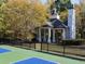 Ornate gazebo near tennis courts, surrounded by trees, with black iron fence at 48 Lakeview Pt, Dallas, GA 30157