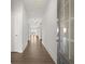 A bright hallway showcases hardwood floors, white walls, and multiple doorways leading to other rooms at 48 Lakeview Pt, Dallas, GA 30157
