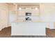 Kitchen features white island with granite countertops, stainless steel appliances, and classic cabinetry at 48 Lakeview Pt, Dallas, GA 30157
