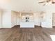 Open concept living room flowing into a kitchen featuring hardwood floors and modern lighting fixtures at 48 Lakeview Pt, Dallas, GA 30157