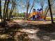 Community playground with colorful slides offers outdoor fun amidst a serene, tree-lined setting, perfect for families at 48 Lakeview Pt, Dallas, GA 30157