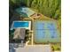 Aerial view of community amenities, including a pool, tennis courts, basketball court, and playground surrounded by trees at 6977 Demeter Dr, Atlanta, GA 30349