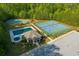 Aerial view of the community amenities, featuring a pool, tennis courts, and basketball court at 6977 Demeter Dr, Atlanta, GA 30349