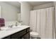 Bright bathroom with a modern sink, dark cabinets, and a shower-tub combo at 6977 Demeter Dr, Atlanta, GA 30349