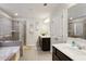 Well-lit bathroom with a double vanity, soaking tub, and a separate glass-enclosed shower at 6977 Demeter Dr, Atlanta, GA 30349