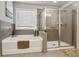 This bathroom has a tile surround tub, separate glass shower, and a large window for natural light at 6977 Demeter Dr, Atlanta, GA 30349