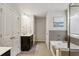 This elegant bathroom features a deep soaking tub, dual closets, and dark wood cabinetry at 6977 Demeter Dr, Atlanta, GA 30349