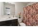 Bright bathroom featuring a dark vanity, shower and bath combo, and decorative floral shower curtain at 6977 Demeter Dr, Atlanta, GA 30349