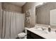 Bathroom features framed art, a vanity, a curtained shower and a toilet at 6977 Demeter Dr, Atlanta, GA 30349