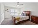 Cozy bedroom with a ceiling fan, plush carpet, natural light, and a comfortable seating area at 6977 Demeter Dr, Atlanta, GA 30349