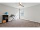 This spare bedroom has neutral walls, carpeted floors, and a ceiling fan to create a soothing space at 6977 Demeter Dr, Atlanta, GA 30349