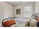 Bright bedroom with a metal bed frame, plush pillows, and a window with ample natural light at 6977 Demeter Dr, Atlanta, GA 30349