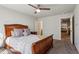 This is a beautiful bedroom with ceiling fan, carpet, and a large bed perfect for a relaxing retreat at 6977 Demeter Dr, Atlanta, GA 30349