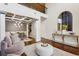 Elegant foyer featuring high ceilings, decorative columns, a statement chandelier, and a cozy seating area at 6977 Demeter Dr, Atlanta, GA 30349