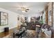 Spacious living room with hardwood floors, a comfortable sectional sofa, and stairs leading to the upper level at 6977 Demeter Dr, Atlanta, GA 30349