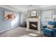 Comfortable living room featuring fireplace and a sunlit window at 6977 Demeter Dr, Atlanta, GA 30349