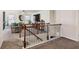 Inviting loft featuring wood railing and a partial view of the living room at 6977 Demeter Dr, Atlanta, GA 30349