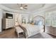 This main bedroom features a tray ceiling, neutral paint, and a spacious layout with ensuite bathroom at 6977 Demeter Dr, Atlanta, GA 30349