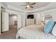 Comfortable main bedroom with tray ceiling, TV, and doorway to adjoining room at 6977 Demeter Dr, Atlanta, GA 30349