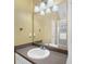 Bathroom features a vanity with a large mirror and decorative lighting fixtures at 8035 Canter Ln, Alpharetta, GA 30009