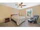 Bedroom featuring a ceiling fan, a cozy chair, and lots of sunlight at 8035 Canter Ln, Alpharetta, GA 30009